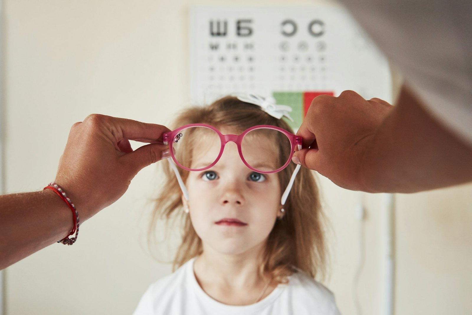 A child reading a vision chart during an eye exam