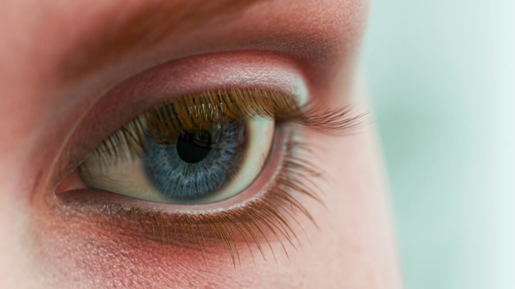 Concept of a pink eye, close up eye shot with pink make up around it in pink
