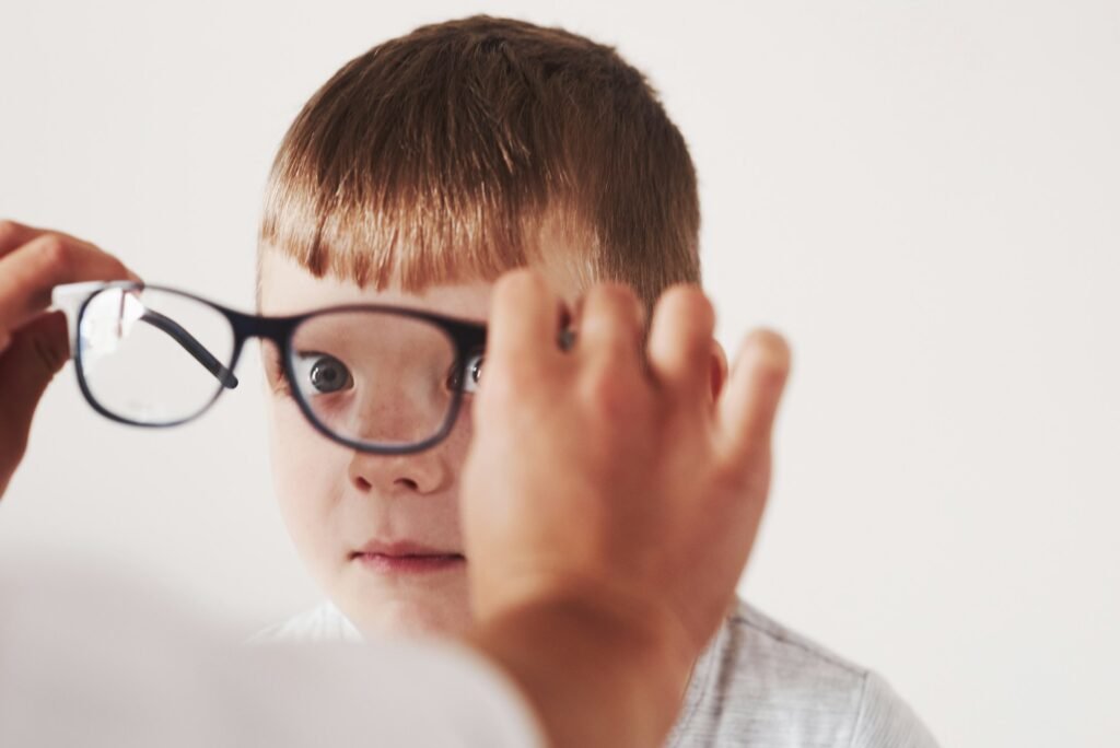kid wearing glasses looking at camera